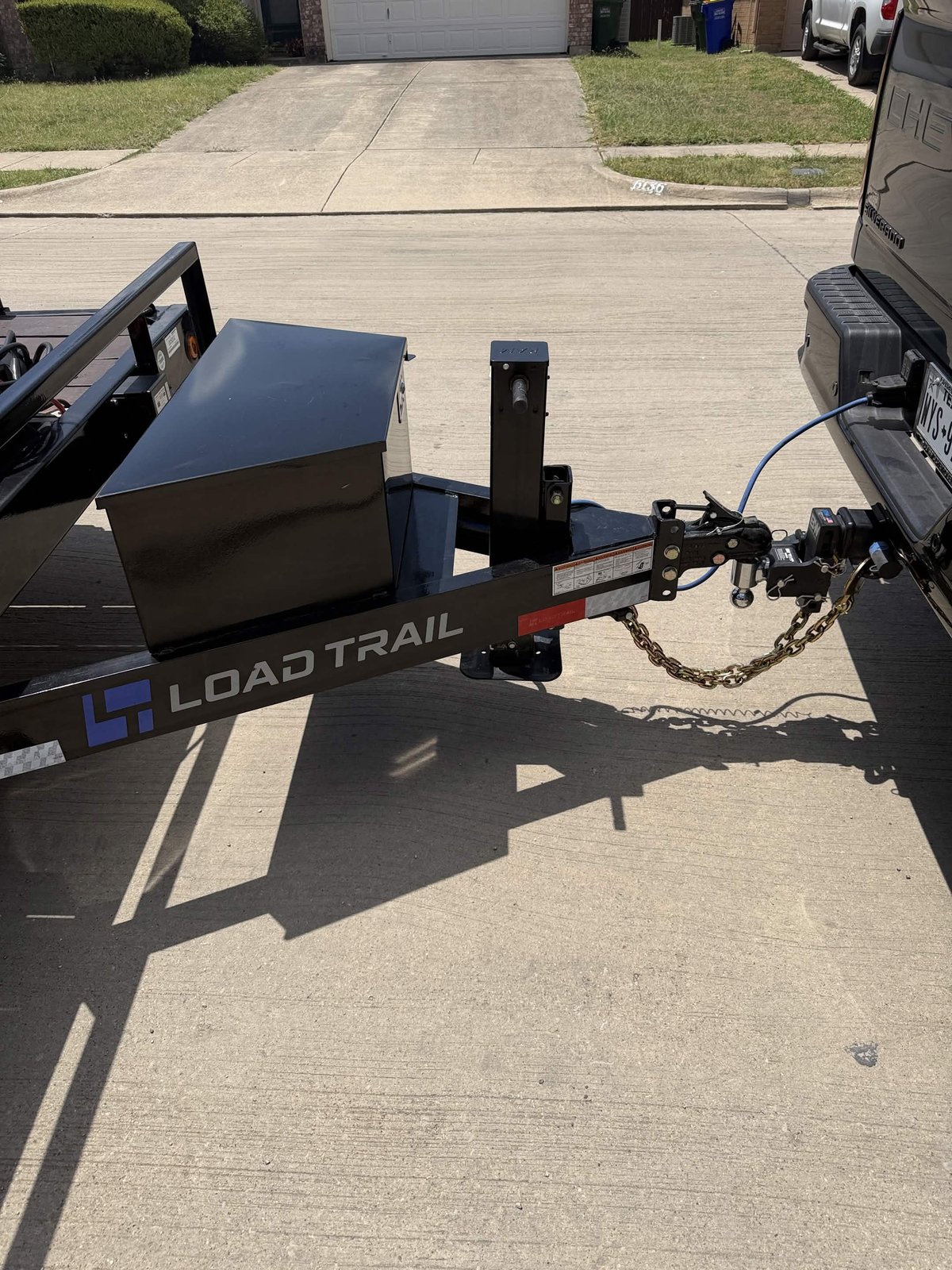 LoadTrail tongue, coupler, safety chain, and toolbox hitched to a truck